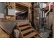 Utility area with modern HVAC system, exposed ductwork, and wooden stairs leading to the basement at 7506 Chipmunk Pl, Littleton, CO 80125