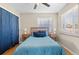 Comfortable bedroom with ample natural light, a ceiling fan, and hardwood flooring at 6925 W 27Th Ave, Wheat Ridge, CO 80033