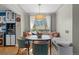 Charming breakfast nook with a built-in banquette, round table, and large window for natural light at 6925 W 27Th Ave, Wheat Ridge, CO 80033