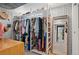 Organized walk-in closet with ample storage, stylish wallpaper, and modern design at 6925 W 27Th Ave, Wheat Ridge, CO 80033