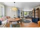 Cozy dining area with a unique light fixture and hardwood floors, adjacent to the living room at 6925 W 27Th Ave, Wheat Ridge, CO 80033