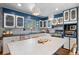 Modern kitchen featuring white cabinets, a large island, and stainless steel appliances at 6925 W 27Th Ave, Wheat Ridge, CO 80033