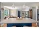 Open kitchen area featuring a kitchen island with white countertop and eat-in seating at 6925 W 27Th Ave, Wheat Ridge, CO 80033