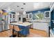 Bright kitchen showcasing an island with seating, stainless steel appliances, and modern finishes at 6925 W 27Th Ave, Wheat Ridge, CO 80033