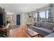 Inviting living room with hardwood floors, a comfortable sectional, and large windows at 6925 W 27Th Ave, Wheat Ridge, CO 80033