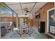 Cozy outdoor dining area with a table, chairs, rug, ceiling fans, TV, and mini fridge under a covered patio at 6925 W 27Th Ave, Wheat Ridge, CO 80033