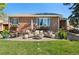 Cozy brick patio with comfortable outdoor seating and a modern fire pit, perfect for relaxing evenings at 6925 W 27Th Ave, Wheat Ridge, CO 80033
