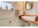 Charming powder room with white vessel sink, decorative mirror, and paneled walls at 5368 Creek Way, Parker, CO 80134