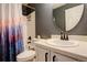 Bathroom featuring gray walls, decorative shower curtain, and a round mirror at 5368 Creek Way, Parker, CO 80134