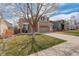 Traditional two-story home with brick and siding, and a well-manicured lawn at 5368 Creek Way, Parker, CO 80134