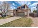 Two-story home with brick facade, a two-car garage and well maintained lawn at 5368 Creek Way, Parker, CO 80134
