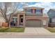 Charming two-story home with brick facade, two-car garage, and landscaped front yard at 5368 Creek Way, Parker, CO 80134