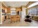 Open kitchen with a center island, stainless appliances, and an adjacent dining area with large windows at 5368 Creek Way, Parker, CO 80134