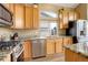 Modern kitchen featuring granite counters, stainless steel appliances, and light wood cabinetry at 5368 Creek Way, Parker, CO 80134