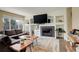 Cozy living room features a fireplace with a dark tile surround and custom shelving at 5368 Creek Way, Parker, CO 80134
