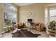 Comfortable living room with large windows, cozy chairs, and stylish decor at 5368 Creek Way, Parker, CO 80134