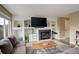 Comfortable living room with fireplace, built-in shelving, and a large sectional sofa at 5368 Creek Way, Parker, CO 80134