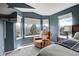 Cozy main bedroom featuring a recliner chair and large windows with natural light at 5368 Creek Way, Parker, CO 80134