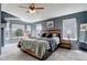 Spacious main bedroom with large windows, a ceiling fan, and a wood-accented headboard at 5368 Creek Way, Parker, CO 80134
