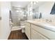 Bright bathroom offers a double vanity with marble countertop and a glass shower at 26229 E Maple Dr, Aurora, CO 80018