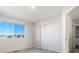 Well-lit bedroom with neutral carpet, a large window and a sliding door closet at 26229 E Maple Dr, Aurora, CO 80018