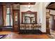 An ornate bar area with dark wood trim, decorative mirror, and seating, perfect for entertaining at 222 Greystone Rd, Evergreen, CO 80439