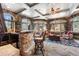 Comfortable bar area with natural stone details, great natural light, and a relaxed seating area at 222 Greystone Rd, Evergreen, CO 80439