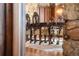 Elegant dining room with hardwood floors, stone walls, and ornately carved wooden furniture at 222 Greystone Rd, Evergreen, CO 80439