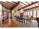 Elegant dining room featuring a fireplace, wood floors, beamed ceiling and large dining table at 222 Greystone Rd, Evergreen, CO 80439