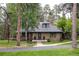 Beautiful stone home with mature trees and a manicured lawn at 222 Greystone Rd, Evergreen, CO 80439