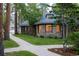 Stone home with a sidewalk leading to the house and lush landscaping at 222 Greystone Rd, Evergreen, CO 80439