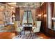 A charming sitting area with wood paneled walls, stone accents, and a large window at 222 Greystone Rd, Evergreen, CO 80439