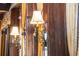 Ornate wall sconce accents the dark wood paneling and adds to the room's ambiance at 222 Greystone Rd, Evergreen, CO 80439