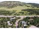 Scenic aerial view of a home nestled amongst trees with a mountain backdrop at 20380 Silver Horn Ln, Monument, CO 80132