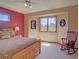 Cozy bedroom features a bay window, rocking chair and warm, natural light at 20380 Silver Horn Ln, Monument, CO 80132