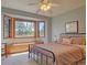 Bright bedroom boasts a beautiful bay window with seating and a modern ceiling fan at 20380 Silver Horn Ln, Monument, CO 80132