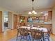 Formal dining area featuring wood floors, ornate chandelier, and kitchen view at 20380 Silver Horn Ln, Monument, CO 80132