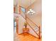 Welcoming foyer with wood floors, a staircase with white railings, and decorative chandelier at 20380 Silver Horn Ln, Monument, CO 80132