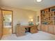Comfortable home office with built-in shelves, a large desk, and carpeted floors at 20380 Silver Horn Ln, Monument, CO 80132