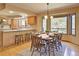 Open concept kitchen and dining area with hardwood floors, breakfast bar and natural light at 20380 Silver Horn Ln, Monument, CO 80132