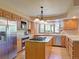 Bright kitchen featuring an island cooktop, modern appliances, marble countertops, and backyard views at 20380 Silver Horn Ln, Monument, CO 80132