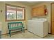 Well-lit laundry room with modern washer/dryer, ample natural light, and a bench at 20380 Silver Horn Ln, Monument, CO 80132