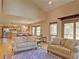 Spacious living area with hardwood floors, ample natural light, and convenient access to the kitchen at 20380 Silver Horn Ln, Monument, CO 80132