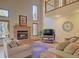 Inviting living area with a brick fireplace, vaulted ceilings, and ample natural light at 20380 Silver Horn Ln, Monument, CO 80132