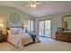 Inviting main bedroom with a ceiling fan, private balcony, and relaxing decor at 20380 Silver Horn Ln, Monument, CO 80132