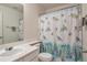 Well-lit bathroom with a charming turtle-themed shower curtain, and a clean white vanity at 9369 Longs Peak Dr, Henderson, CO 80640