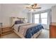 Calm bedroom with an updated bed frame and headboard plus plenty of light from two large windows at 9369 Longs Peak Dr, Henderson, CO 80640