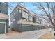 Stylish townhomes featuring private garages, modern architecture, and well-maintained landscaping, showcasing curb appeal at 9369 Longs Peak Dr, Henderson, CO 80640