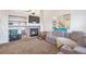 Cozy living room features a fireplace, built-in shelves, and comfortable seating, perfect for relaxing and entertaining at 9369 Longs Peak Dr, Henderson, CO 80640