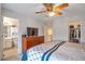 A very large main bedroom featuring a ceiling fan and an attached bathroom and walk-in closet at 9369 Longs Peak Dr, Henderson, CO 80640